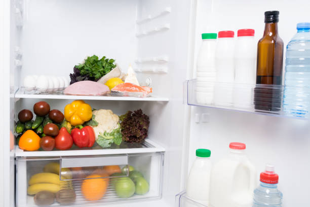 istock vegetables and fruits lie inside a white open refrigerator 1184194237