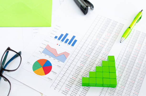 istock Financial documents, with green cubes arranged in a column graph as a concept 1184196239