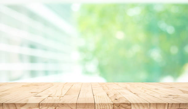 istock Empty wood table top on blur abstract green garden from window view background 1184196636