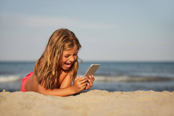 istock Little girl on the beach 1184197324