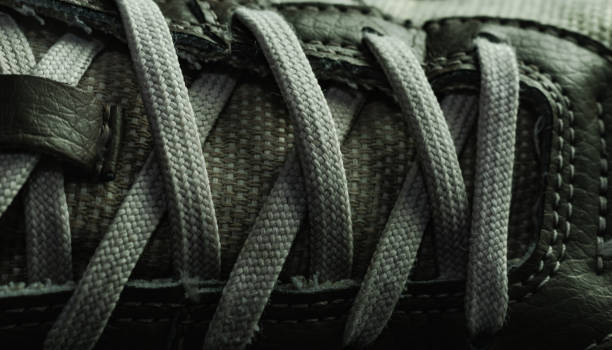 istock Beautiful white shoeloces on a dark background texture. 1184199948