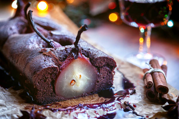 Pear chocolate cake with mulled wine glaze Homemade chocolate cake with pears poached in red wine glaze pear dessert stock pictures, royalty-free photos & images