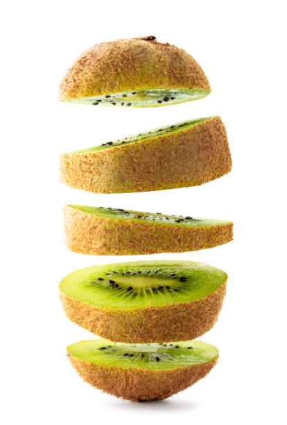 istock Kiwi cut into pieces flying on a white, isolated. 1184200483