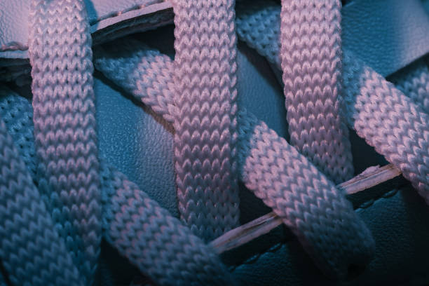 istock Close up beautiful white shoeloces with color light background texture. Macro photography view. 1184201439