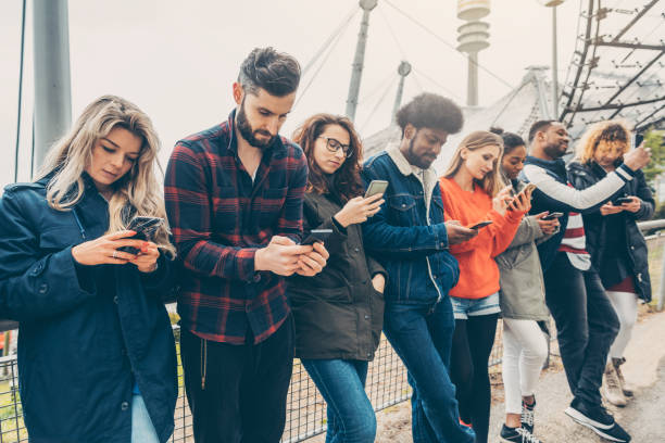 istock Group of young people staring on their phones 1184201660