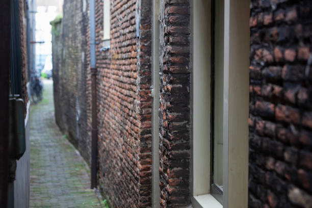 Narrow vintage alley with old brick walls