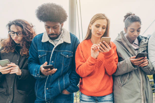 istock People choosing their phones over personal interaction 1184201735