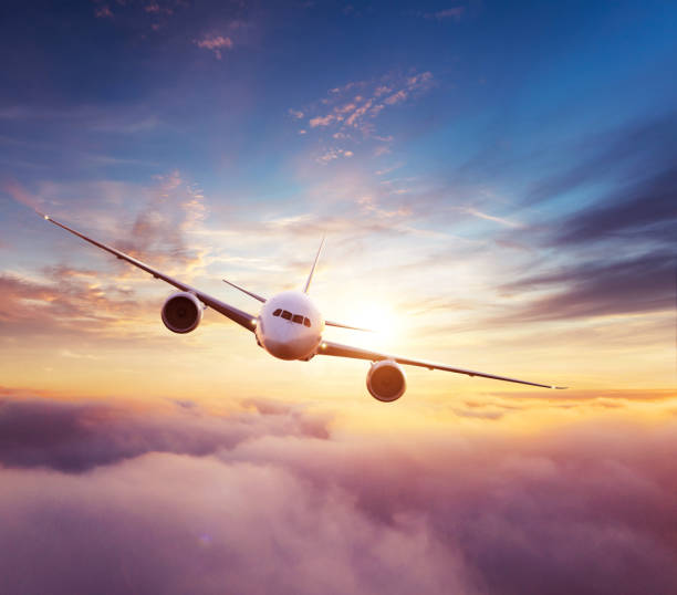 istock Commercial airplane flying over dramatic sunset 1184201883