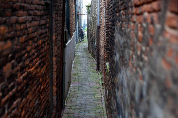 istock Narrow vintage alley with old brick walls 1184201918