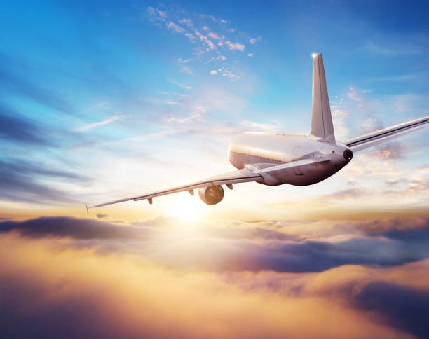 Passengers commercial airplane flying above clouds