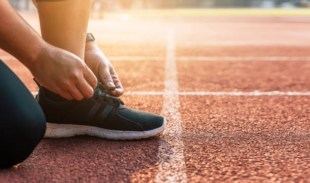 istock Man prepare to start running closeup on shoe 1184203298