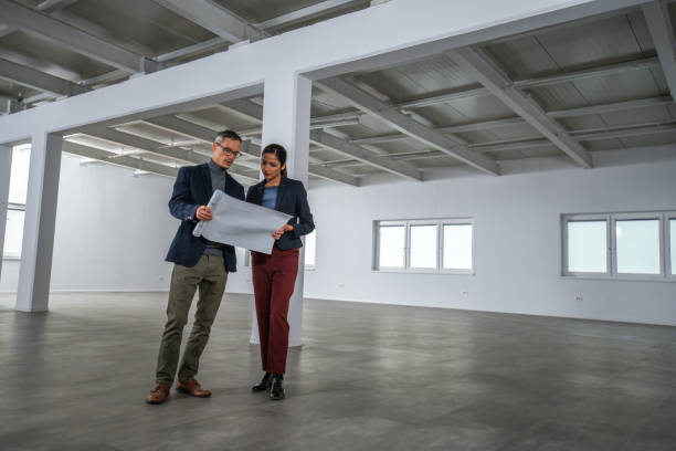 istock Business people discussing blueprint 1184203954
