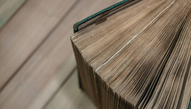istock Close up Beautiful old book on a wooden table background. Top view. 1184204128