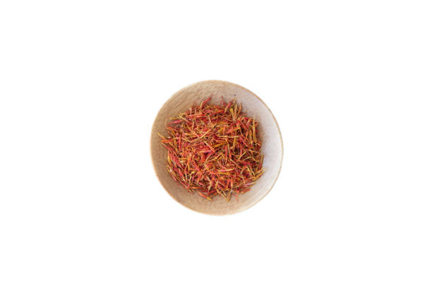Saffron in wooden bowl isolated on white background.