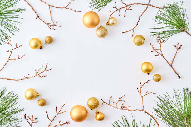 istock Flat lay frame with gold christmas balls and pine branches on a white background 1184207406