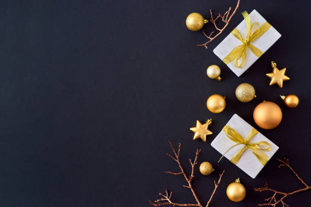 istock Flat lay border with gold christmas balls and gift box on a dark background 1184207453