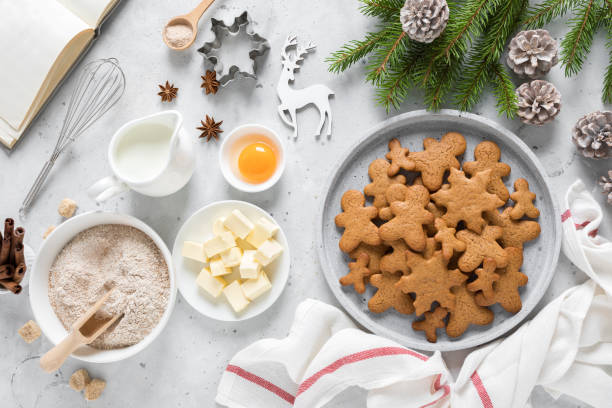 istock Christmas baking culinary background. Xmas gingerbread on kitchen table and ingredients for cooking festive cookies. New Year holiday decorations 1184207485