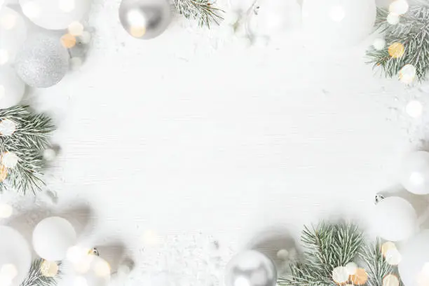 Photo of White Christmas background with spruce frosty brunches and Christmas lights