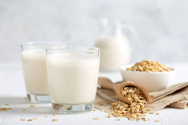 hafermilch. gesundes veganes nicht-milch-bio-getränk mit flocken - milk white stock-fotos und bilder