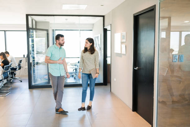 istock Business Colleagues Walking Along Office Corridor 1184209351