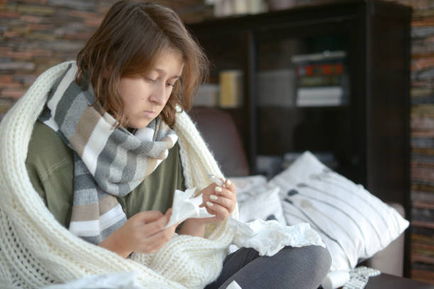 istock young girl is sick in the room 1184210122