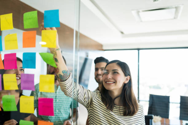 istock Female Professional Discussing With Team 1184211478