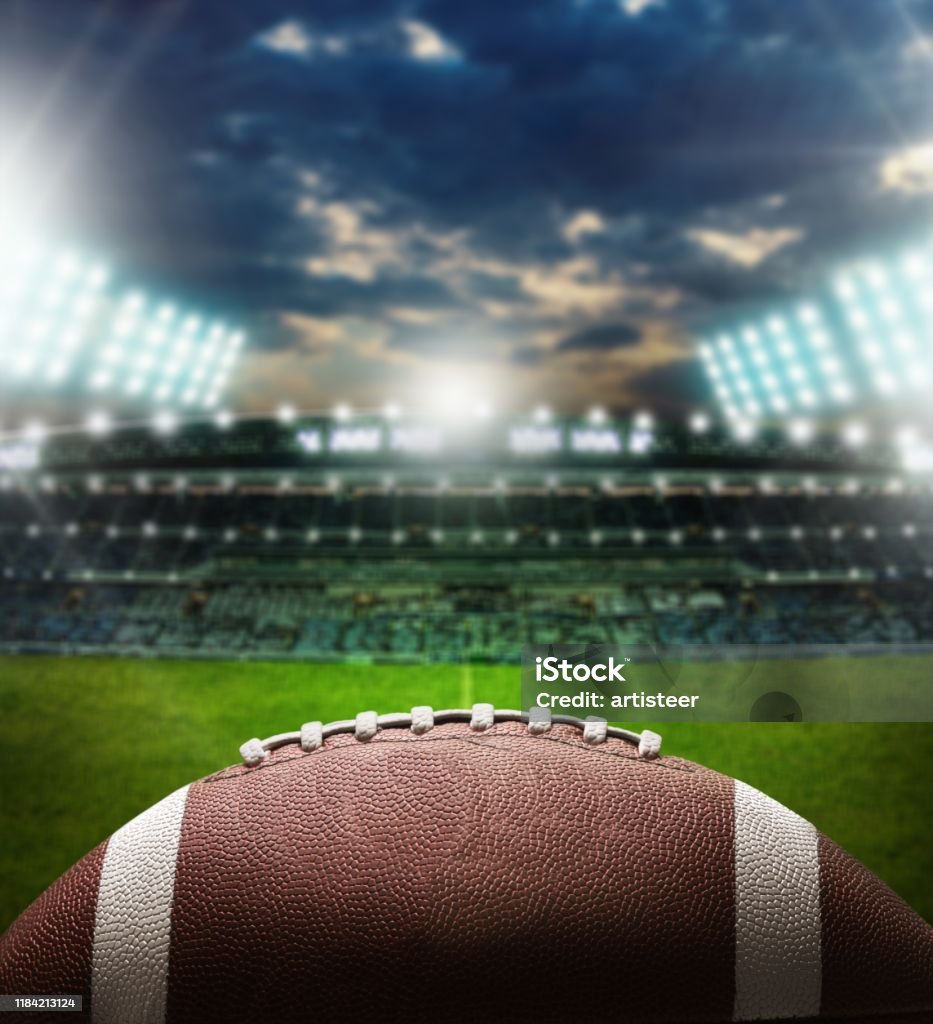 American. Night football arena in lights with a ball close up College American Football Stock Photo