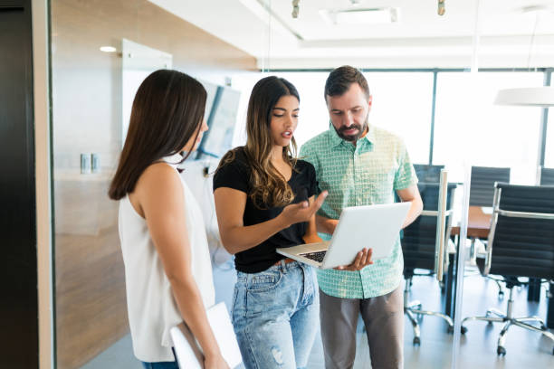istock Mangers Planning Over Laptop At Passage In Office 1184213438