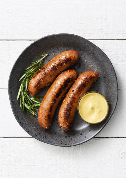 Sausages with dijon mustard sauce and seasoning stock photo