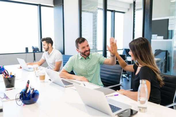 istock Professionals Celebrating Success With High-Five 1184213699