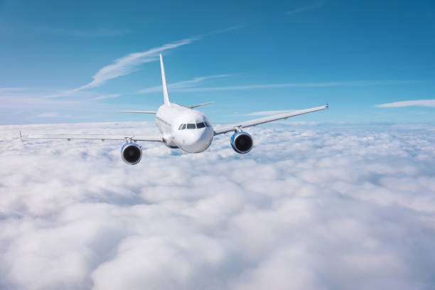 istock Passenger plane flies over overcast on a sunny day. 1184215378