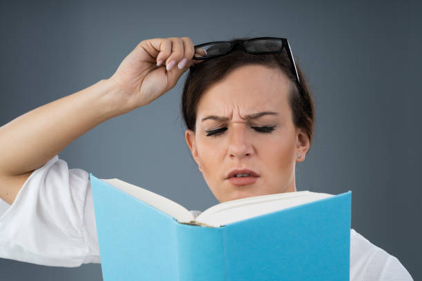 istock Young Woman Trying To Read Book 1184215954