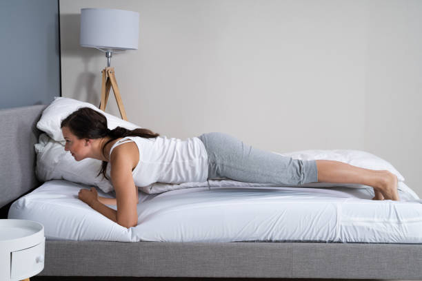 istock Woman Exercising In Bed 1184216016