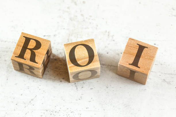 istock Three wooden cubes with letters ROI (stands for Return on Investment) on white board. 1184219517
