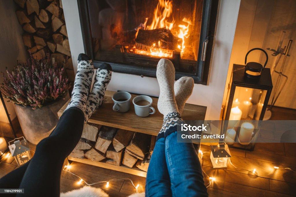 Winter day by fireplace Lazy winer day in front of fire in fireplace. Winter Stock Photo