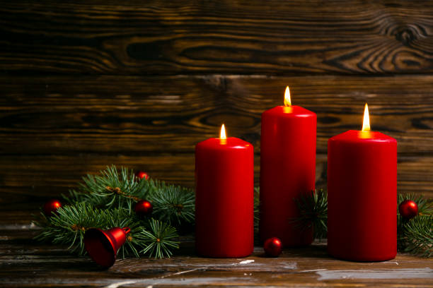 istock Bunch of candles burning over textured background. 1184219951