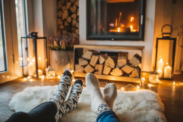 Winter day by fireplace Lazy winer day in front of fire in fireplace. cottage life stock pictures, royalty-free photos & images