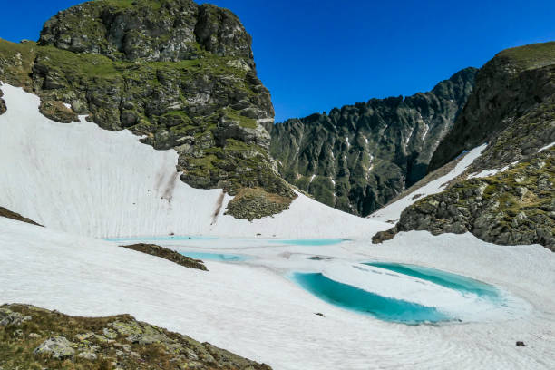 istock Schladming - Ice covered lake in tall mountains 1184222006