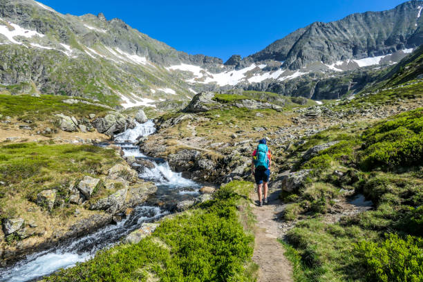 Schladming - A gilr hiking up a path along the mountain stream