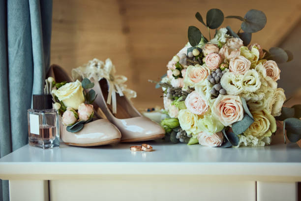 istock bridal accessories such as shoes, bouquet , ring and perfume lie on a table 1184222704