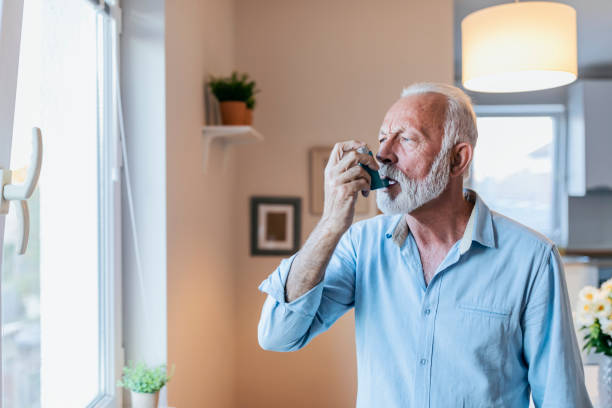 istock Senior man about to use asthma inhaler 1184224246