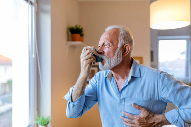 istock Senior man about to use asthma inhaler 1184224251
