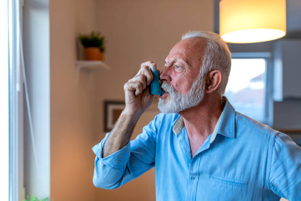 istock Senior man about to use asthma inhaler 1184224264