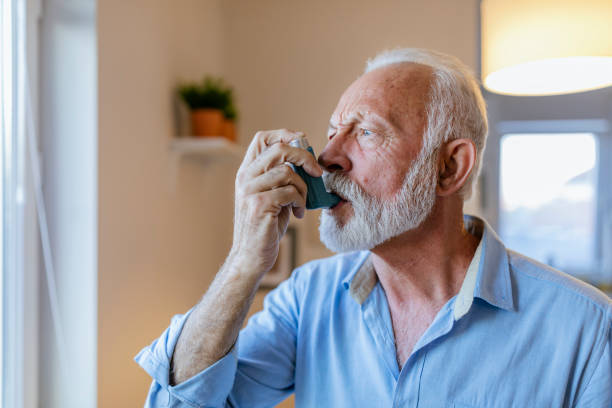 istock Senior man about to use asthma inhaler 1184224343