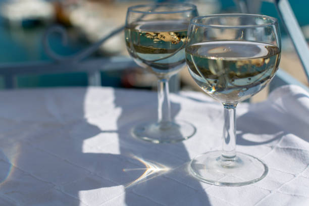 istock White wine served outside on balcony on glass table with sea view 1184224466