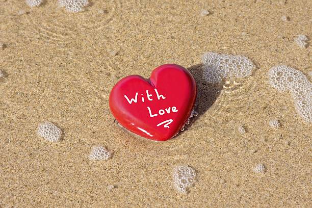 istock With Love: Valentine heart at the beach 118422474