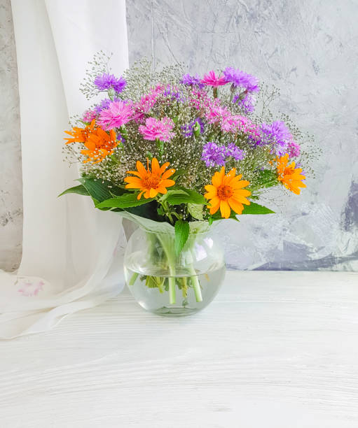istock summer flowers in a vase on a concrete background 1184224910