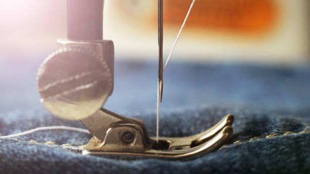istock sewing machine and item of clothing macro 1184224971
