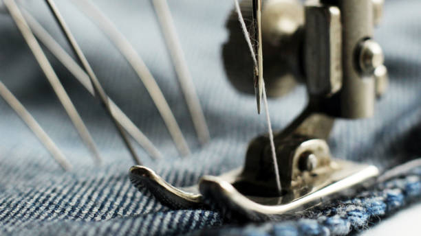 istock sewing machine and item of clothing, macro 1184225543