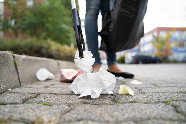 Woman Collecting Trash Outdoors Woman Collecting Trash Outdoors Using Litter Picker littering stock pictures, royalty-free photos & images